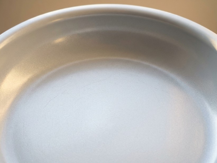 Close-up of ceramic cookware interior showing smooth mineral-based coating surface
