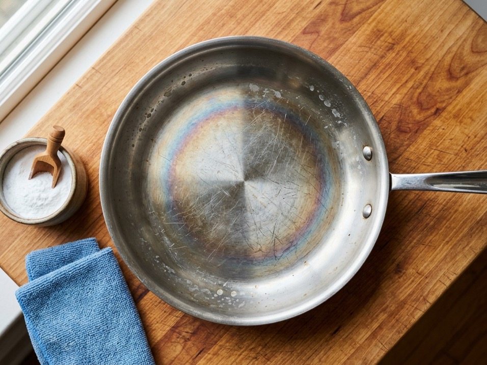 Stainless steel pan with rainbow discoloration and surface scratches after years of regular use